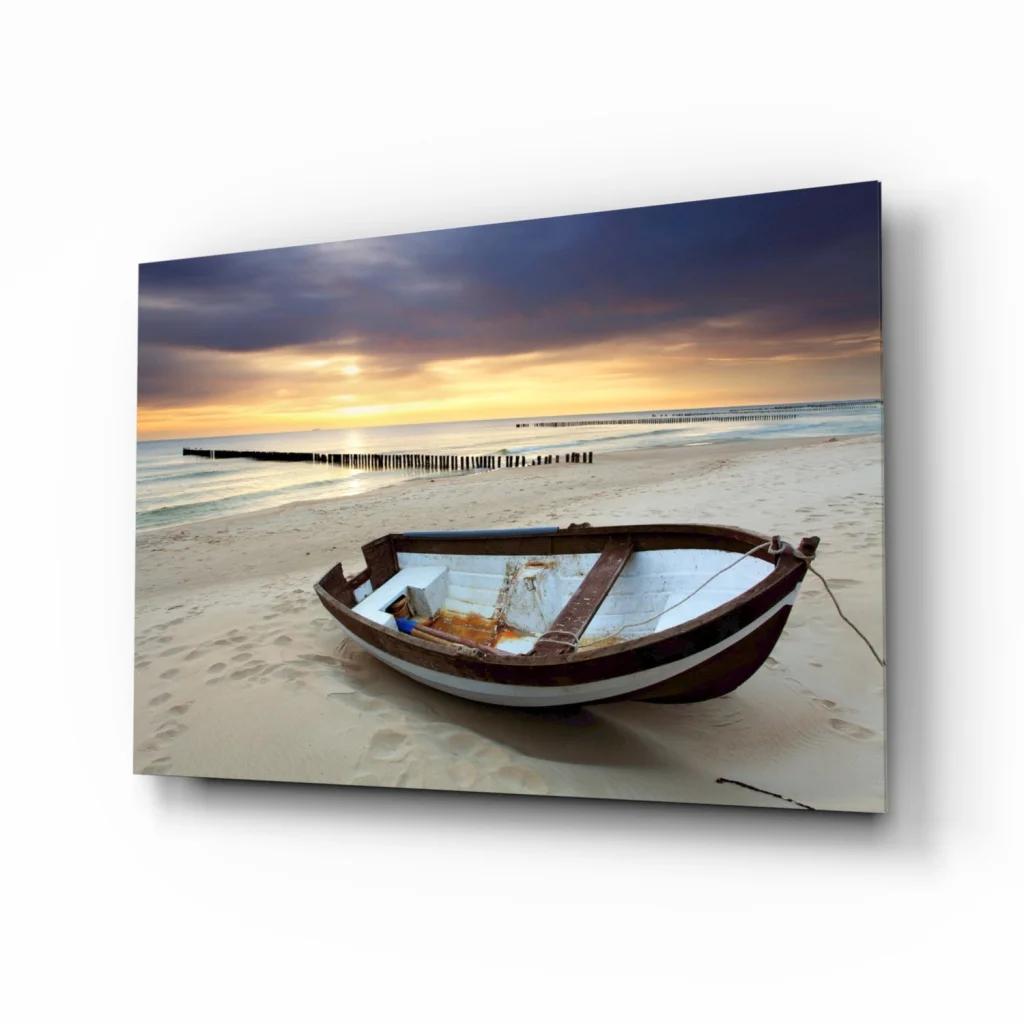 Weathered rowboat on sunset beach in glass wall art print