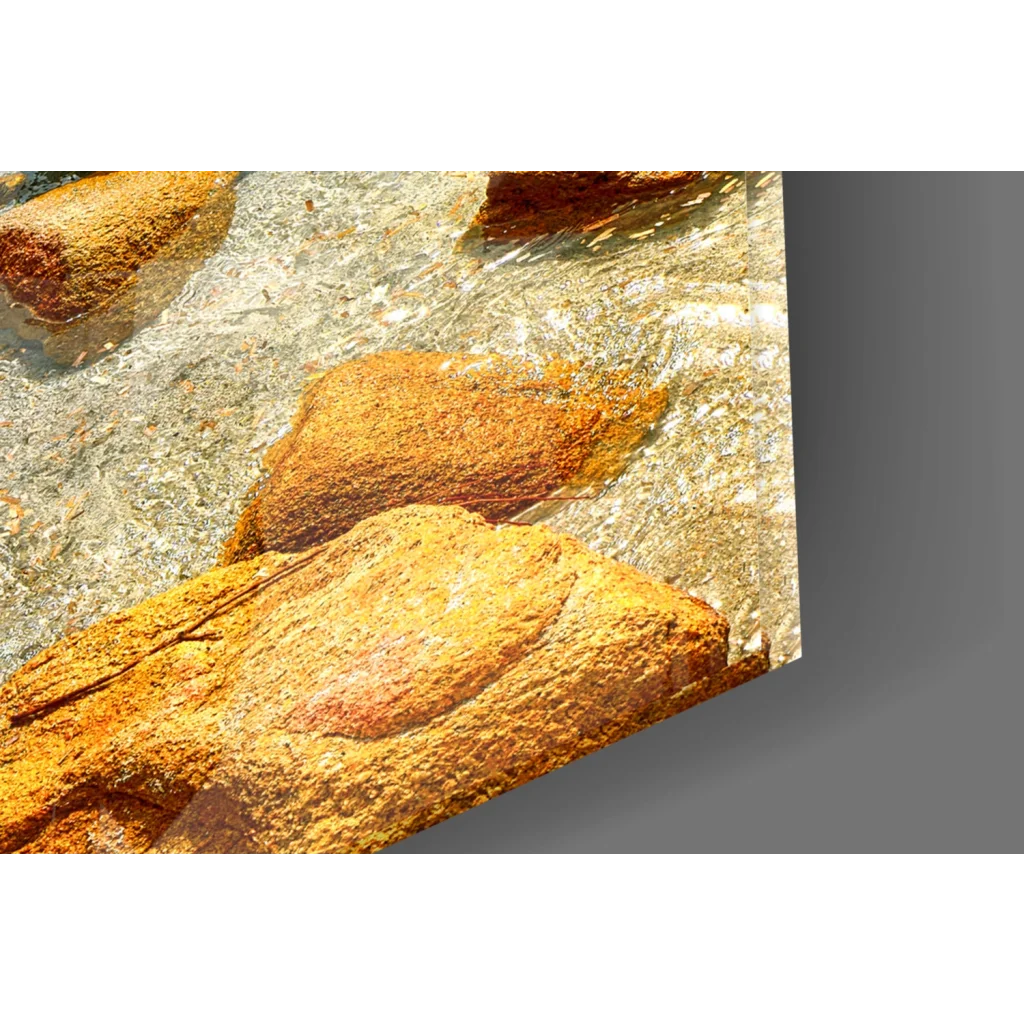 Rust-colored textured rocks in turquoise glass wall art waters
