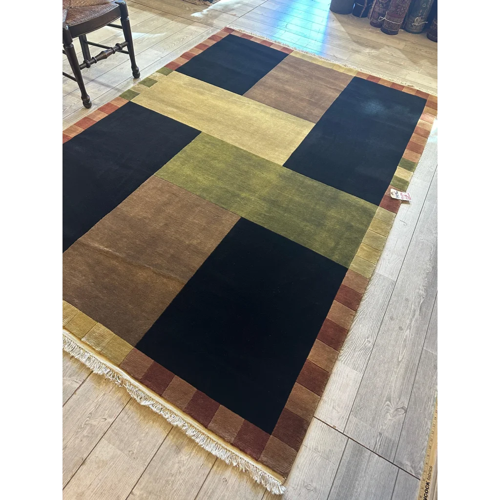 Abstract geometric patchwork area rug, hand-knotted wool India, bold colors in geometric blocks