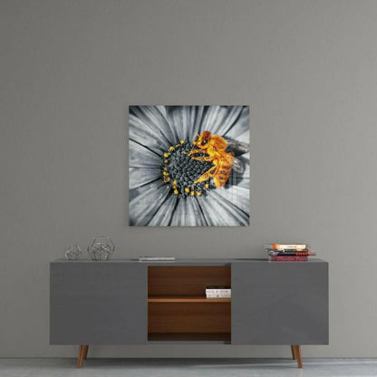 Golden bee on grayscale daisy glass wall art with selective color pop