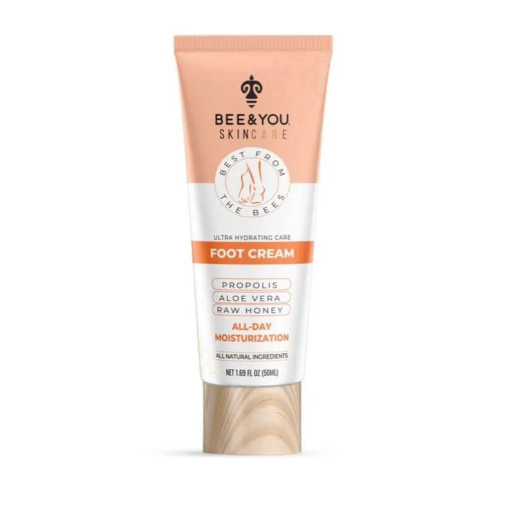 Bee & You skincare foot cream in peach white tube on wood base
