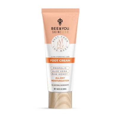 Bee & You skincare foot cream in peach white tube on wood base