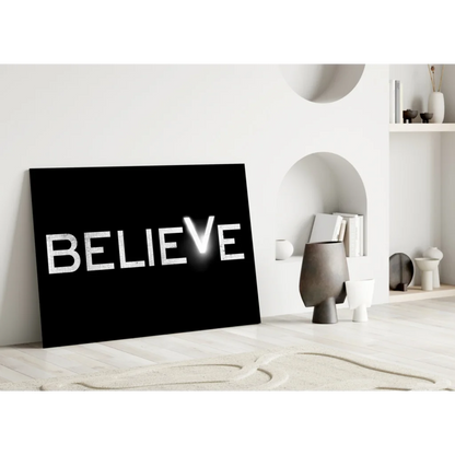 Black canvas wall art with glowing Believe in distressed white letters
