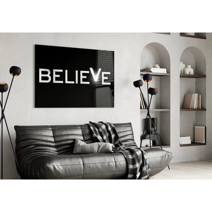 Black canvas wall art with bold white Believe letters