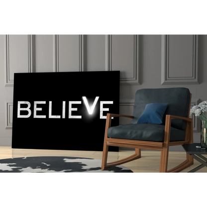 Black canvas wall art with bold white Believe lettering