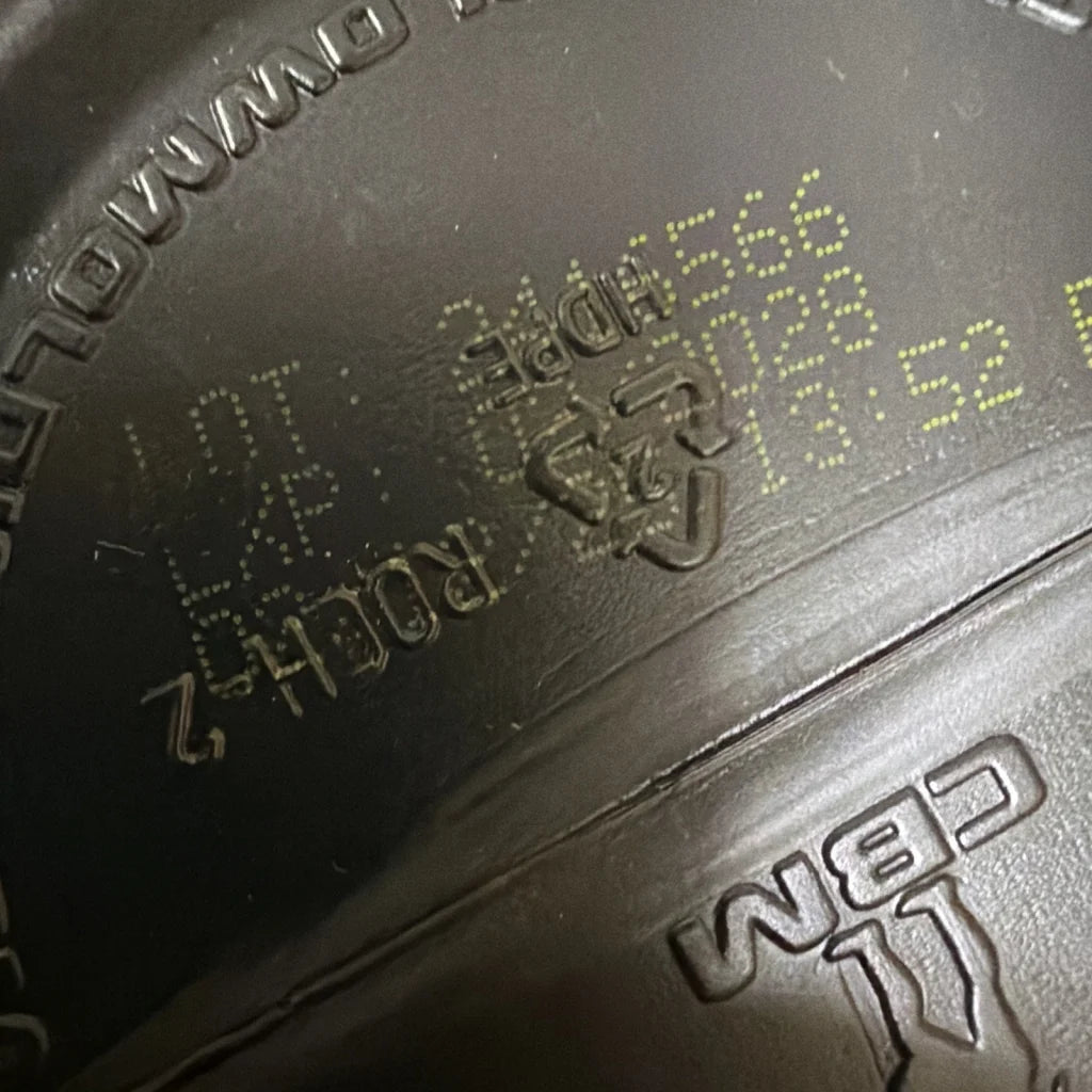 Black rubber tire sidewall with yellow dot matrix code, Raw Lit Pre workout powder