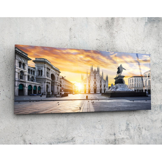 Glass wall art mounted on concrete showing Milan's Duomo cathedral and equestrian statue at golden sunset.