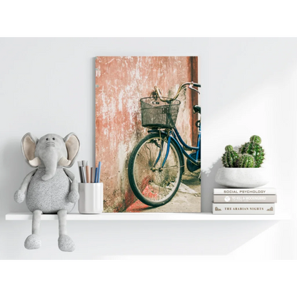Blue bicycle with black basket against pink wall on Insigne aluminum print