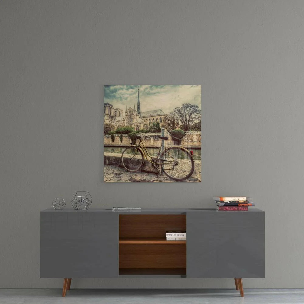 Vintage yellow bicycle by Seine with Notre Dame in sepia tones, glass wall art