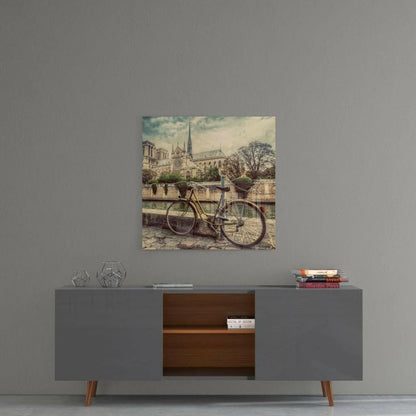 Vintage yellow bicycle by Seine with Notre Dame in sepia tones, glass wall art