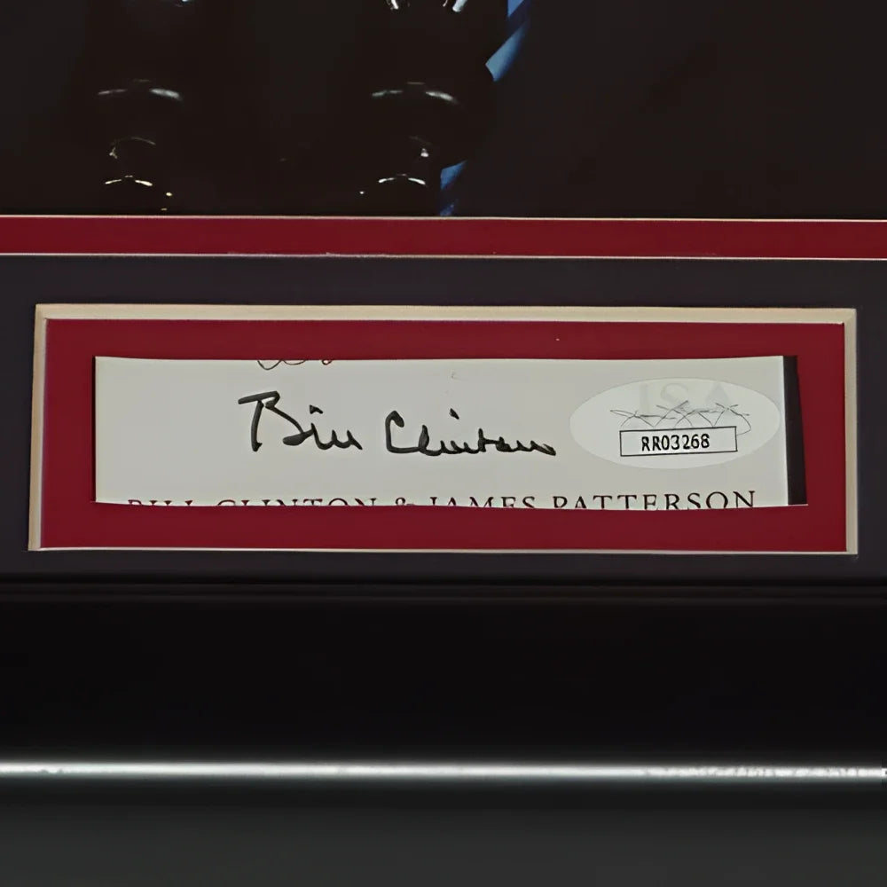 Framed clinton autographed president signature on white label with red border and black matting in signature series frame