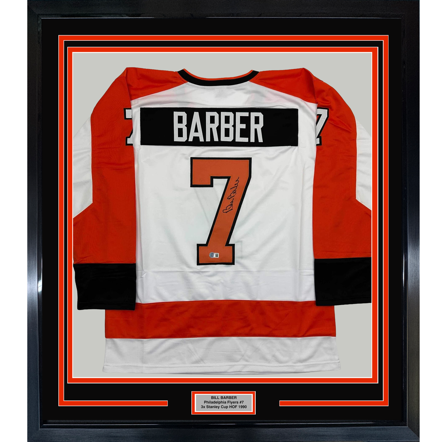 Framed Philadelphia Flyers hockey jersey number 7 signed by Bill Barber, displayed flat against white matting with red and black border frame.