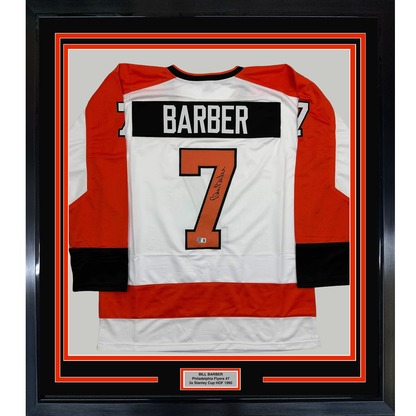 Framed Philadelphia Flyers hockey jersey number 7 signed by Bill Barber, displayed flat against white matting with red and black border frame.