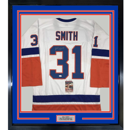 Framed white New York Islanders hockey jersey #31 with "Smith" nameplate and signature, displayed front-facing with blue and red striping and JSA authentication certificate.