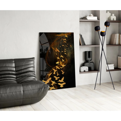 Modern black-framed glass wall art of swirling golden birds in flight