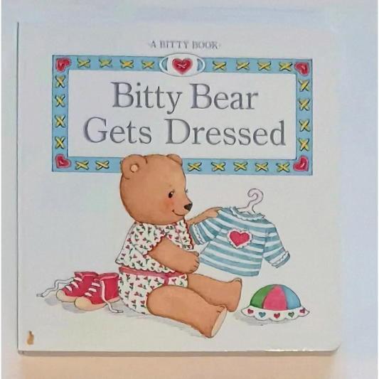 Bitty Baby board book with teddy bear in pink pajamas holding heart shirt