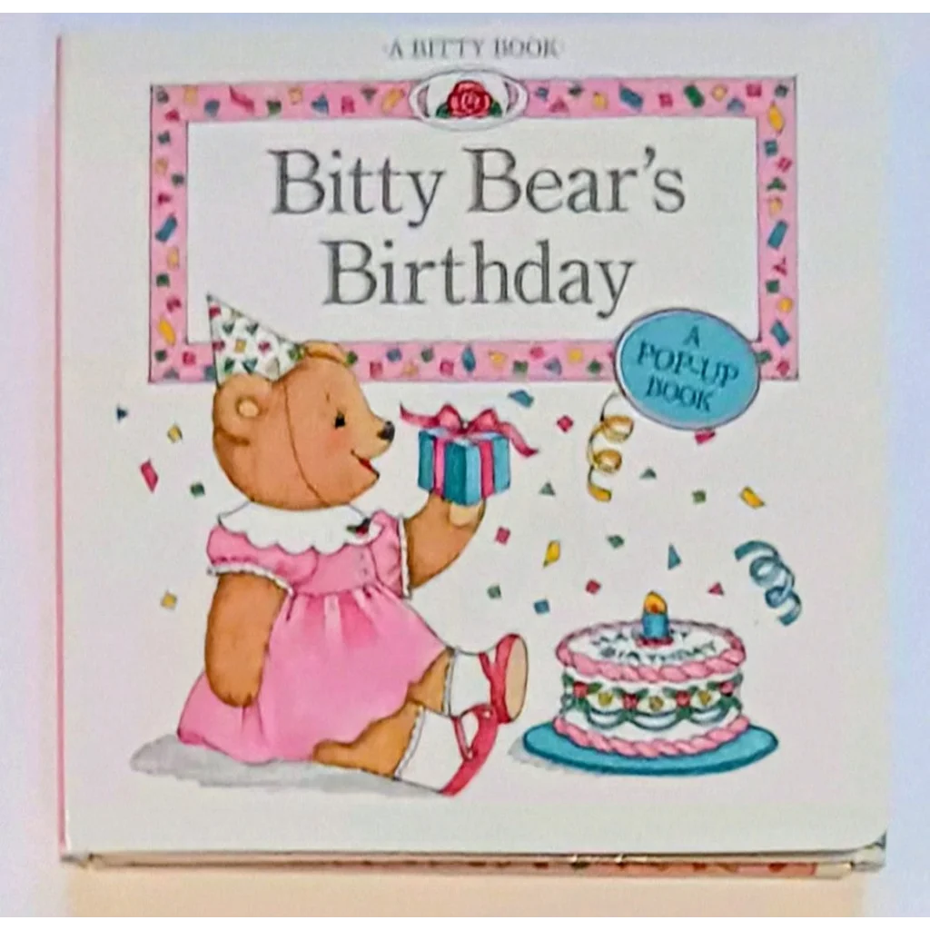 Charming Bitty Bear in pink holds gift by cake in Bitty Baby pop-up book