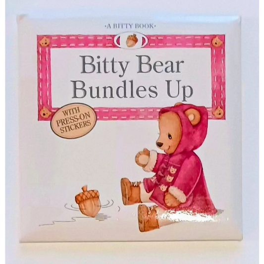 Pink Bitty Bear in hooded coat with stickers on Bitty Baby book cover