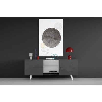 Modern gray console table under textured gray circle glass wall art