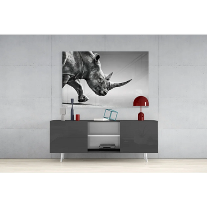 Black-and-white charging rhino wall art on gray wall above console