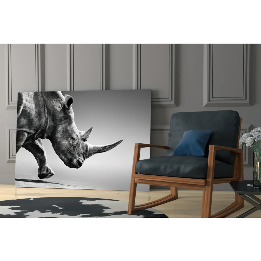 Black-and-white charging rhino canvas wall art on wall