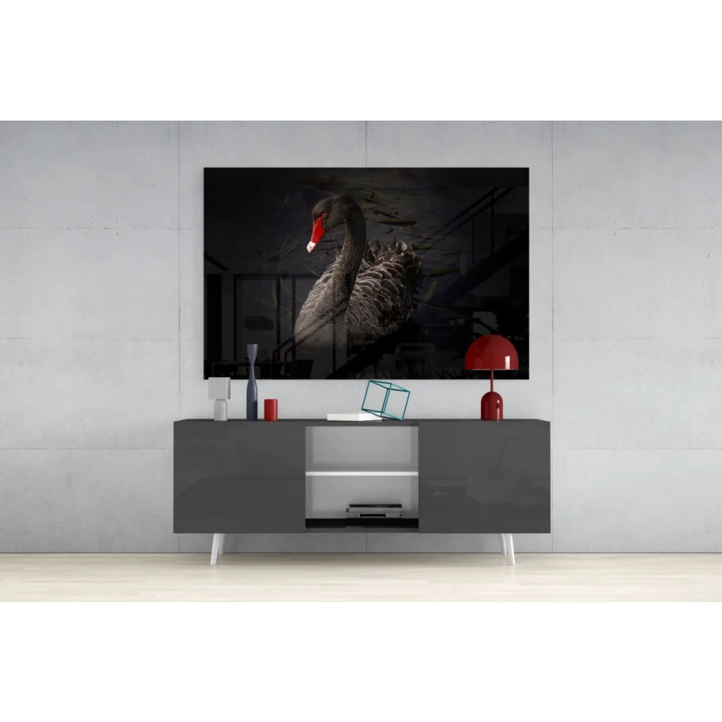 Dramatic black swan glass wall art with bold red beak on gray console