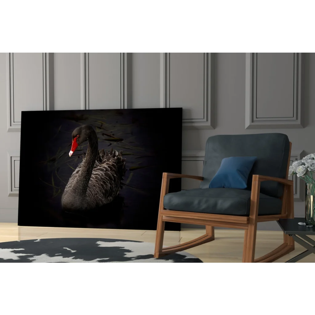 Dramatic black swan glass wall art with bold red beak in elegant interior
