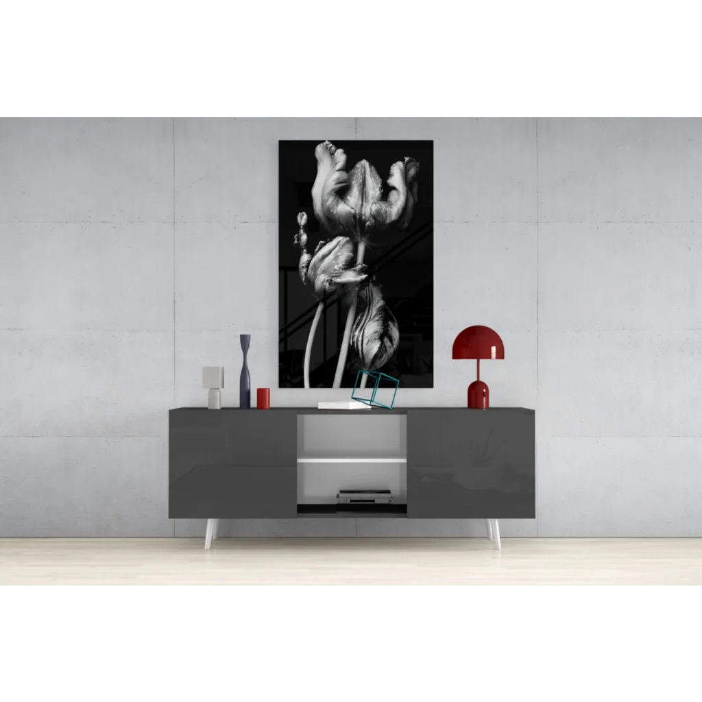 Black-and-white flowers glass wall art above gray console
