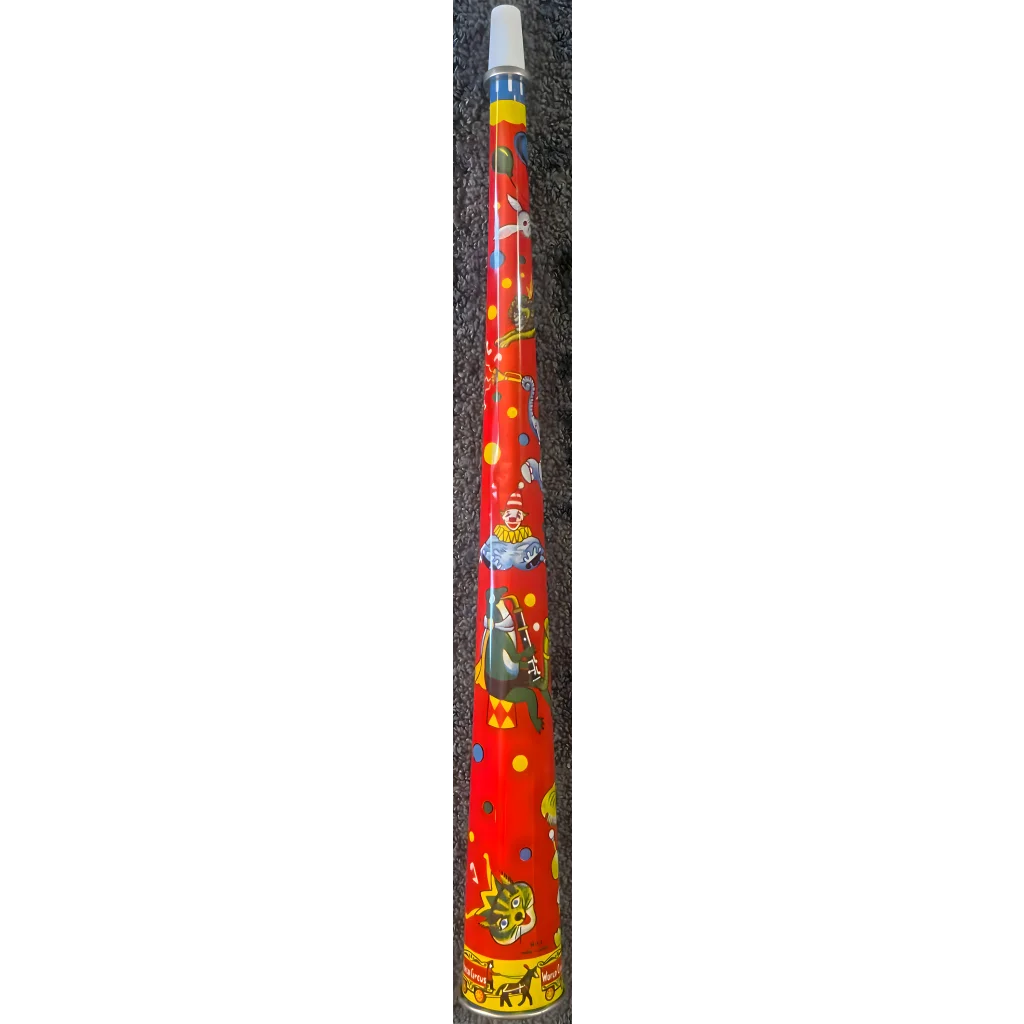 Colorful didgeridoo with vibrant Aboriginal art next to a retro tin horn noisemaker