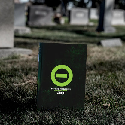 Dark green Bloody Kisses album cover with bright green circle and bar by Alan Robert