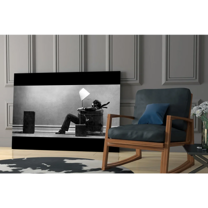 Dark blue rocking chair in striking black and white wall art scene