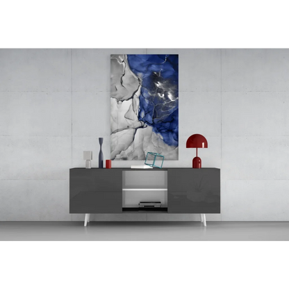 Modern gray sideboard with white legs and silver accents under blue abstract wall art