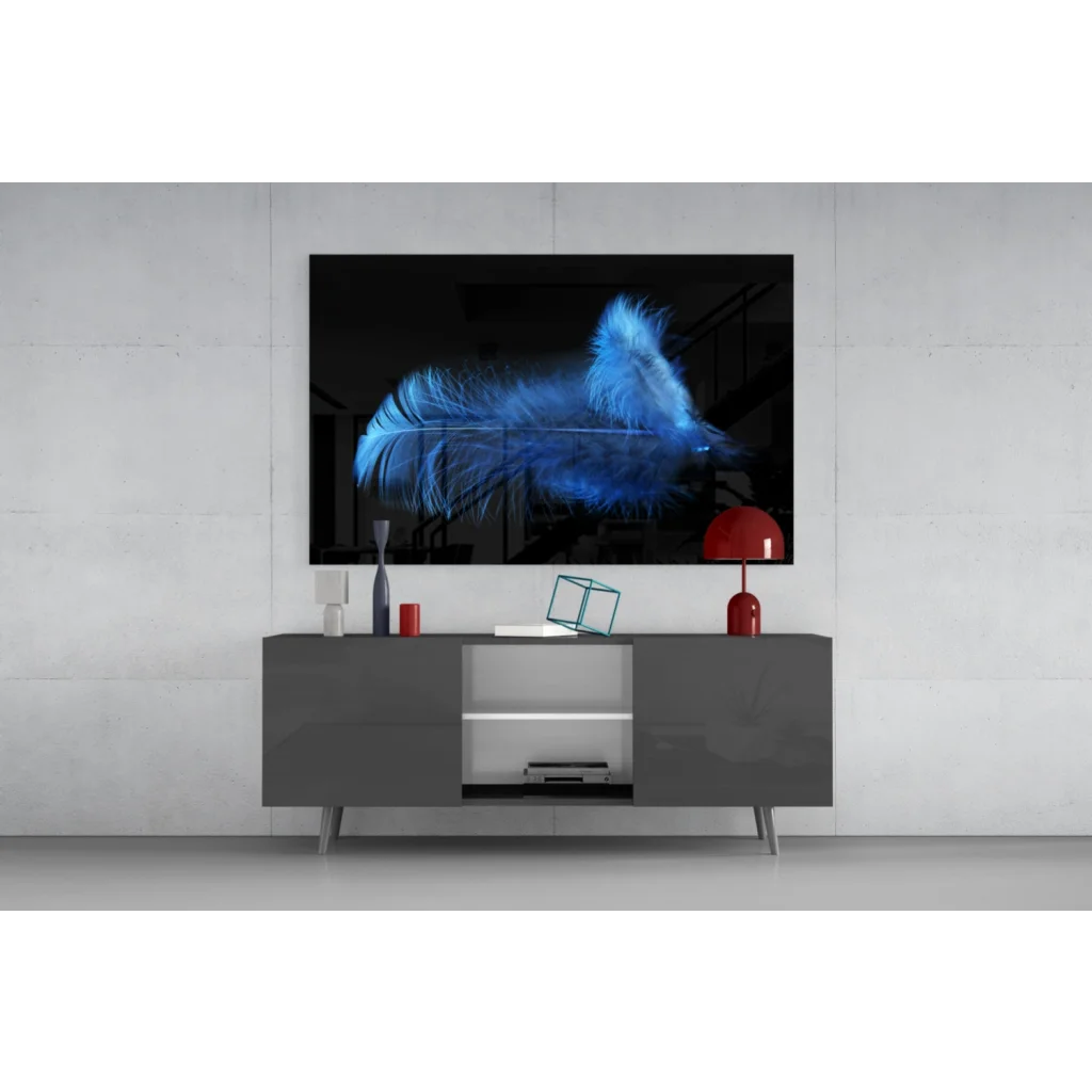 Striking glowing blue feather glass wall art on black canvas atop gray console