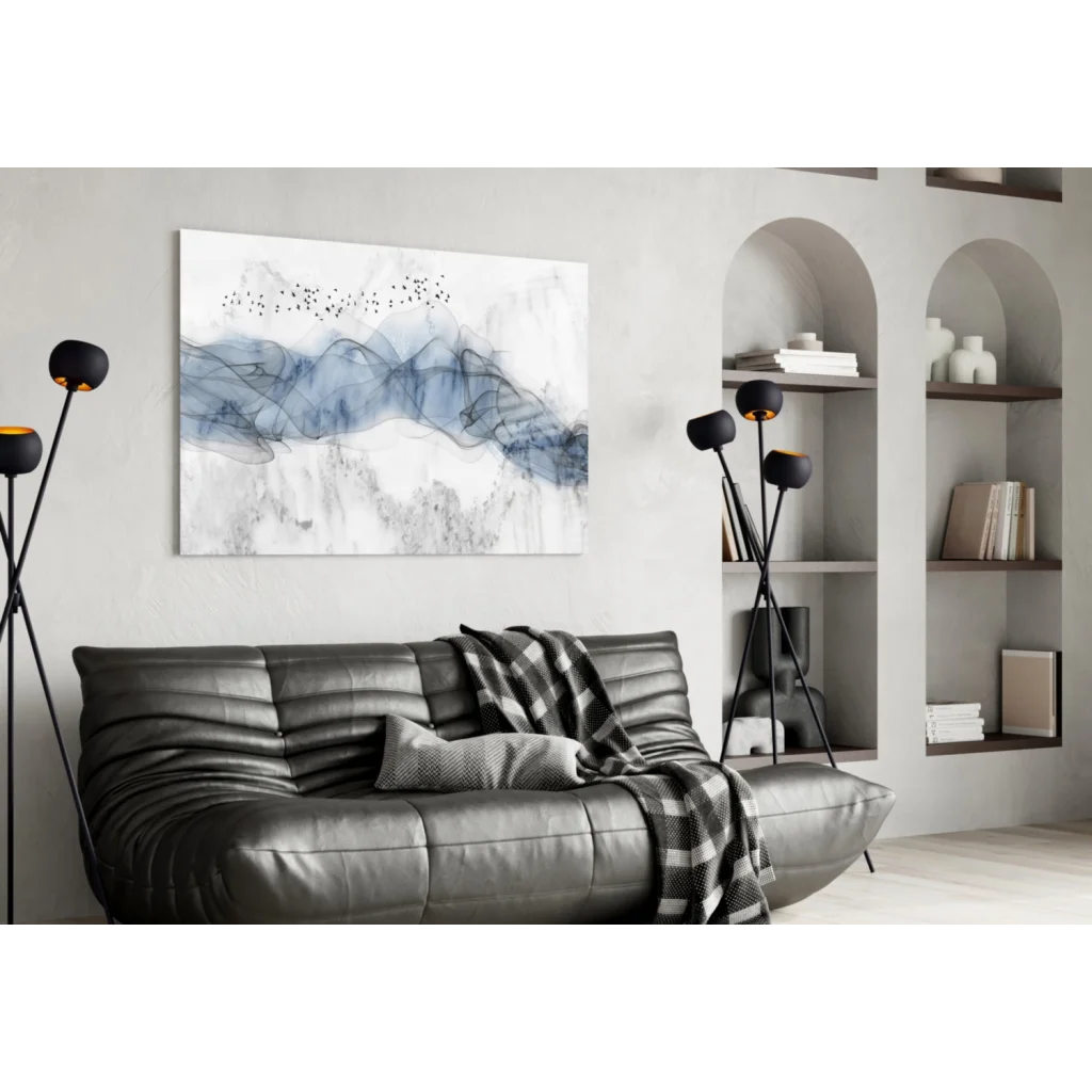 Modern gray leather sofa with plaid blanket under Blue Marble Birds in Flight glass wall art