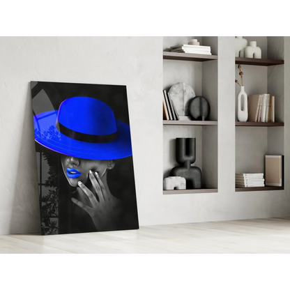 Vibrant blue fedora on woman with bold lips in monochrome glass wall art