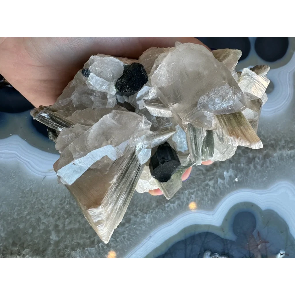 Blue indicolite tourmaline on matrix from Nuristan, Afghanistan, in hand