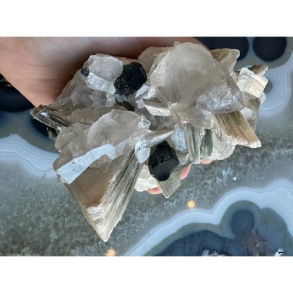 Blue indicolite tourmaline on matrix from Nuristan, Afghanistan, in hand