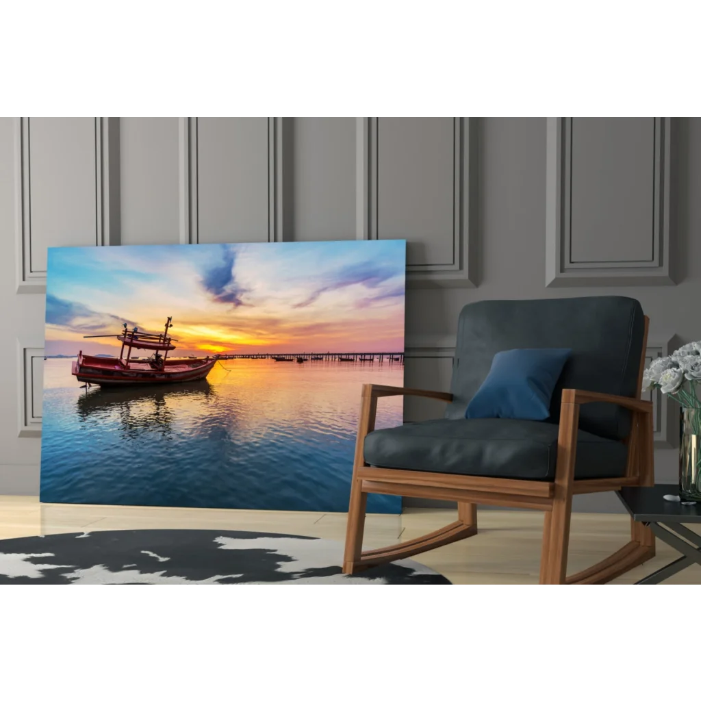 Vibrant sunset glass wall art with red boat on calm water