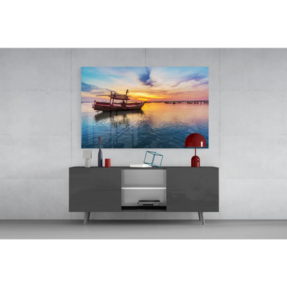 Vibrant sunset glass wall art print of red fishing boat on calm water