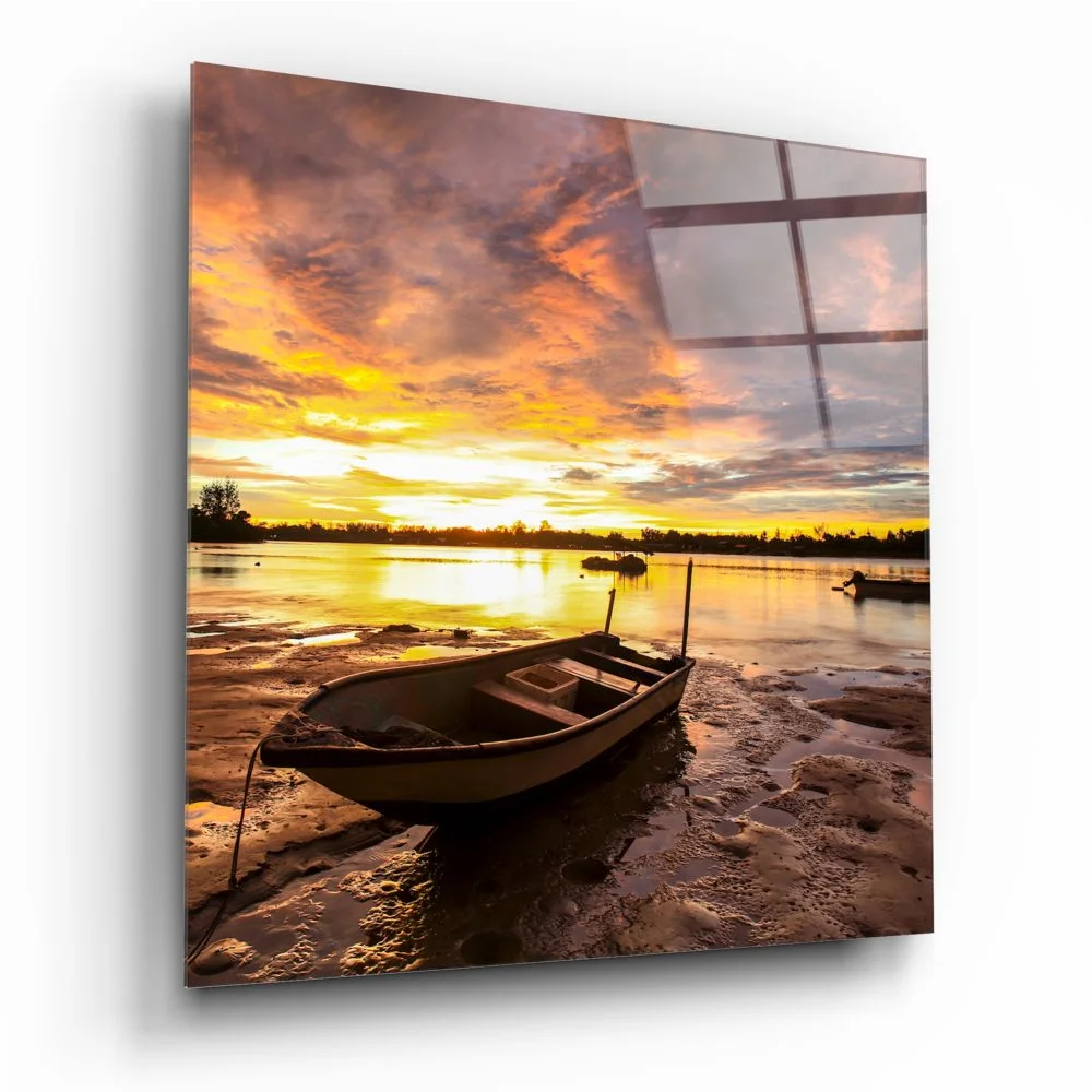 Serene sunset over water with rowboat on shore in tempered glass art