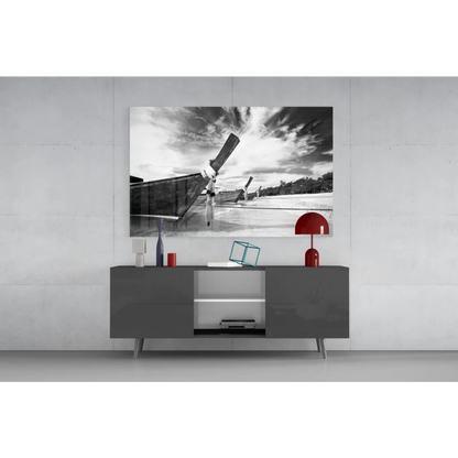 Black and white longtail boat canvas wall art with upward propeller against dramatic sky