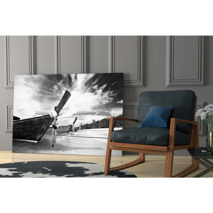 Black-and-white canvas wall art of longtail boats on beach under dramatic skies