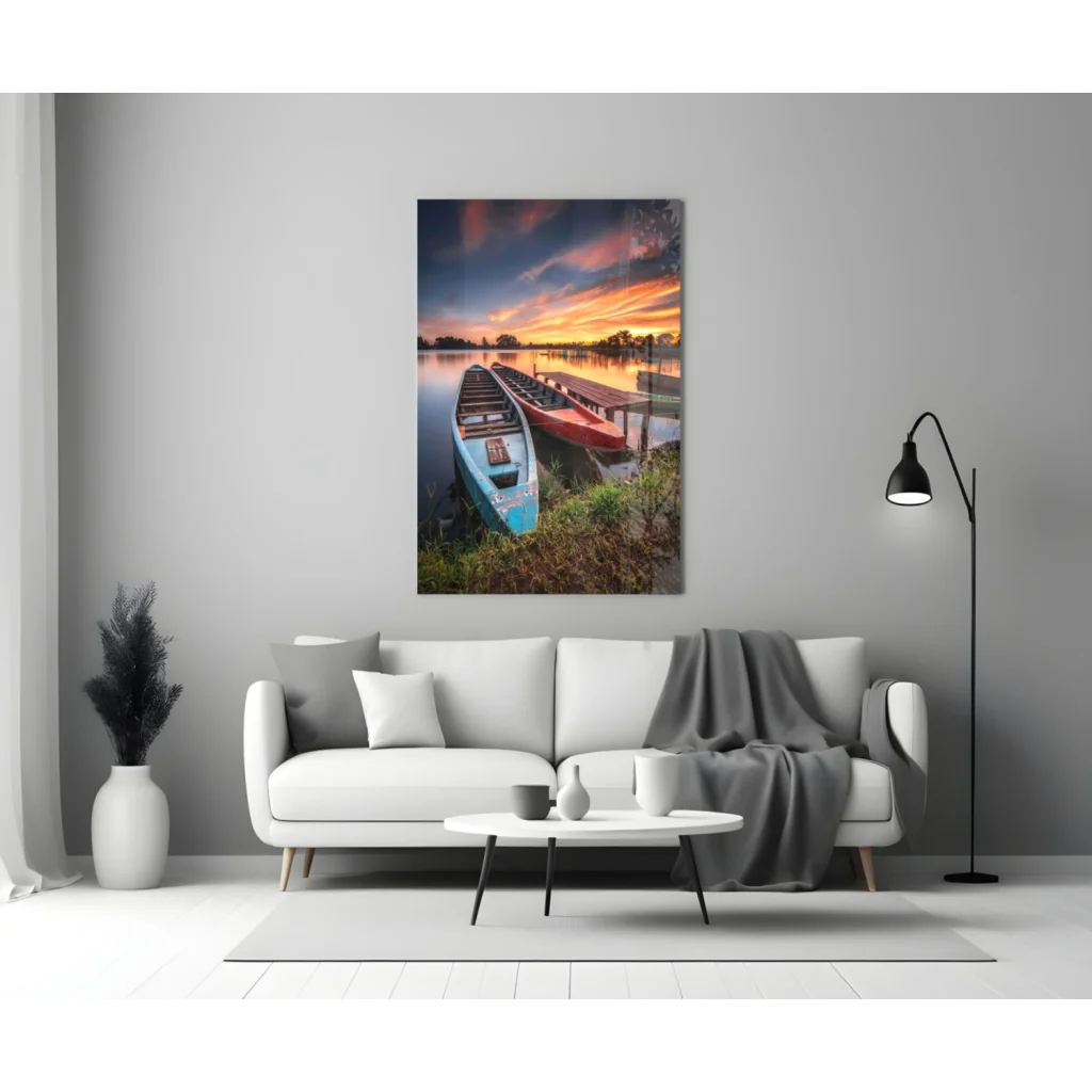 Serene lakeside sunset glass wall art with blue and red boats