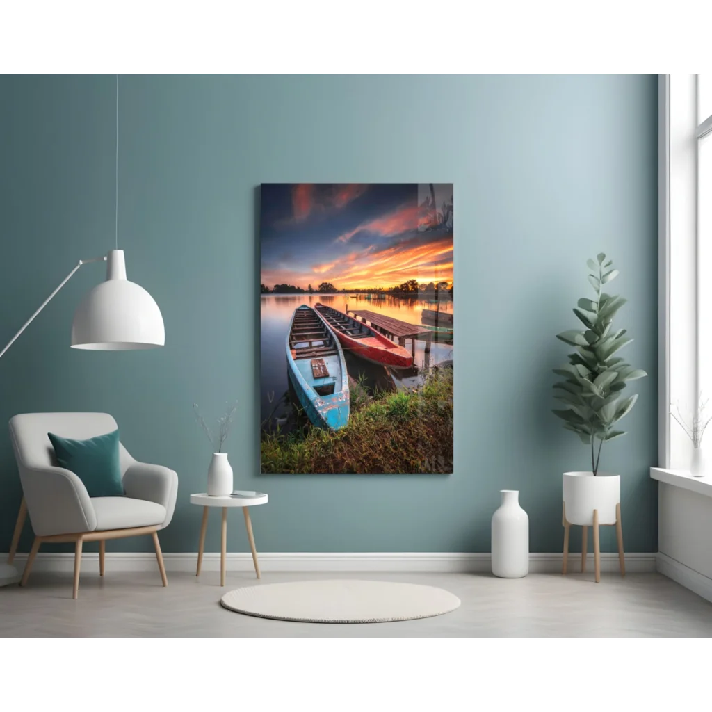 Vibrant lakeside sunset glass wall art with blue and red kayaks at dock