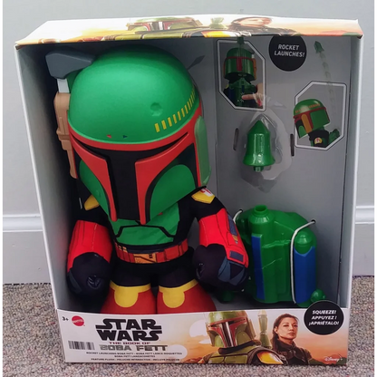 Green and red Star Wars Boba Fett toy with rocket launcher in box