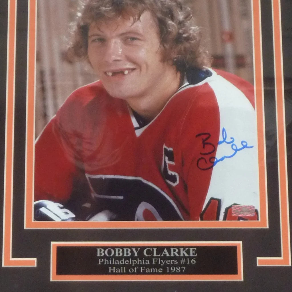 Autographed deluxe framed 8x10 philadelphia flyers 8x10 photo of bobby clarke in red and white jersey with orange border