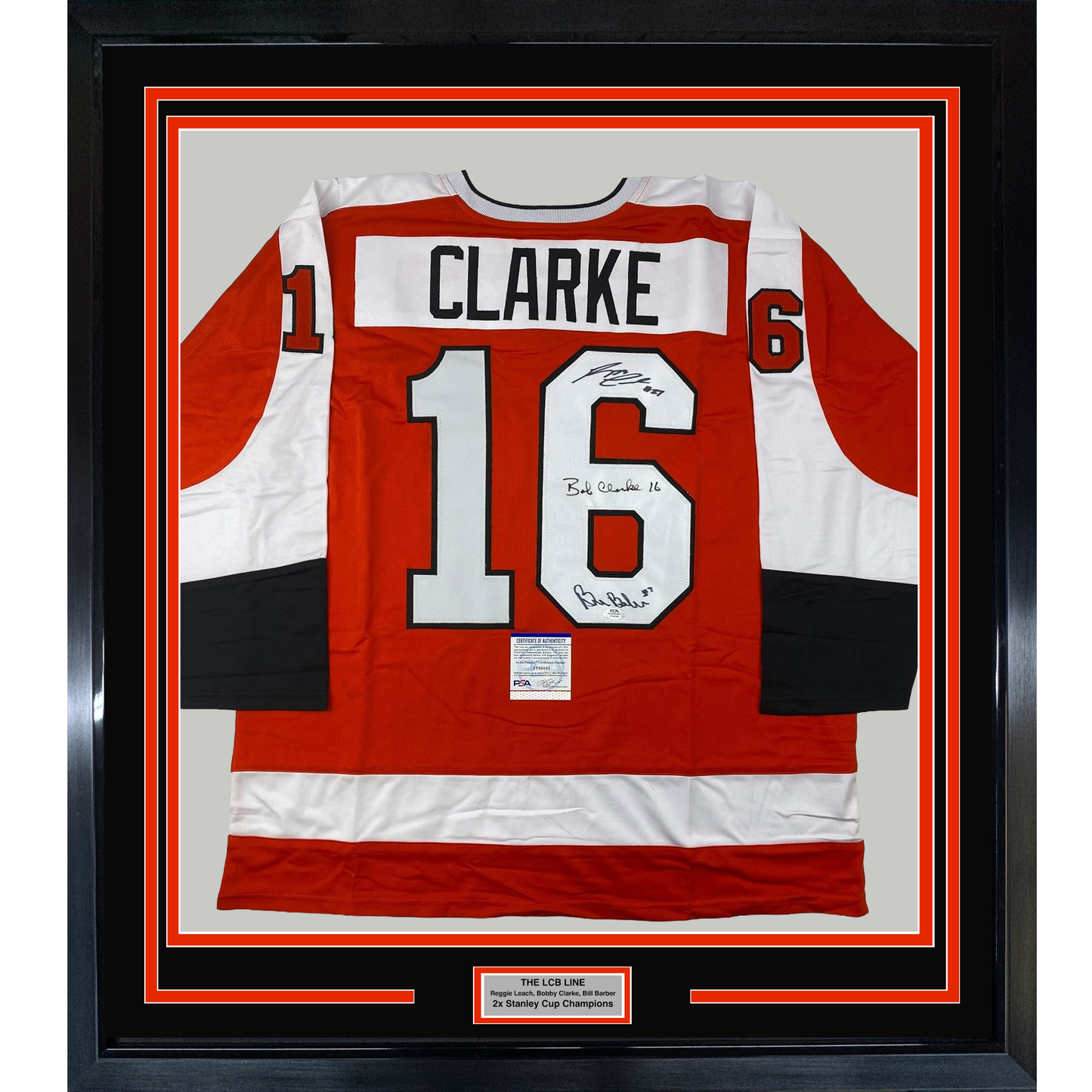 Framed red, white, and black Philadelphia Flyers hockey jersey number 16 with "CLARKE" nameplate, signed in black ink, displayed front-facing.