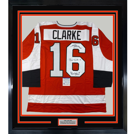 Framed red, white, and black Philadelphia Flyers hockey jersey number 16 with "CLARKE" nameplate, signed in black ink, displayed front-facing.