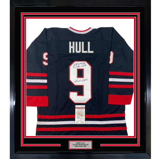 Framed Chicago Blackhawks jersey number 9 with "HULL" nameplate, navy with red and white stripes, displaying autograph and JSA authentication certificate.