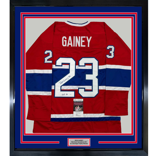 Framed Montreal Canadiens red, white, and blue hockey jersey number 23 signed by Bob Gainey with HOF 1992 inscription and authentication certificate visible.